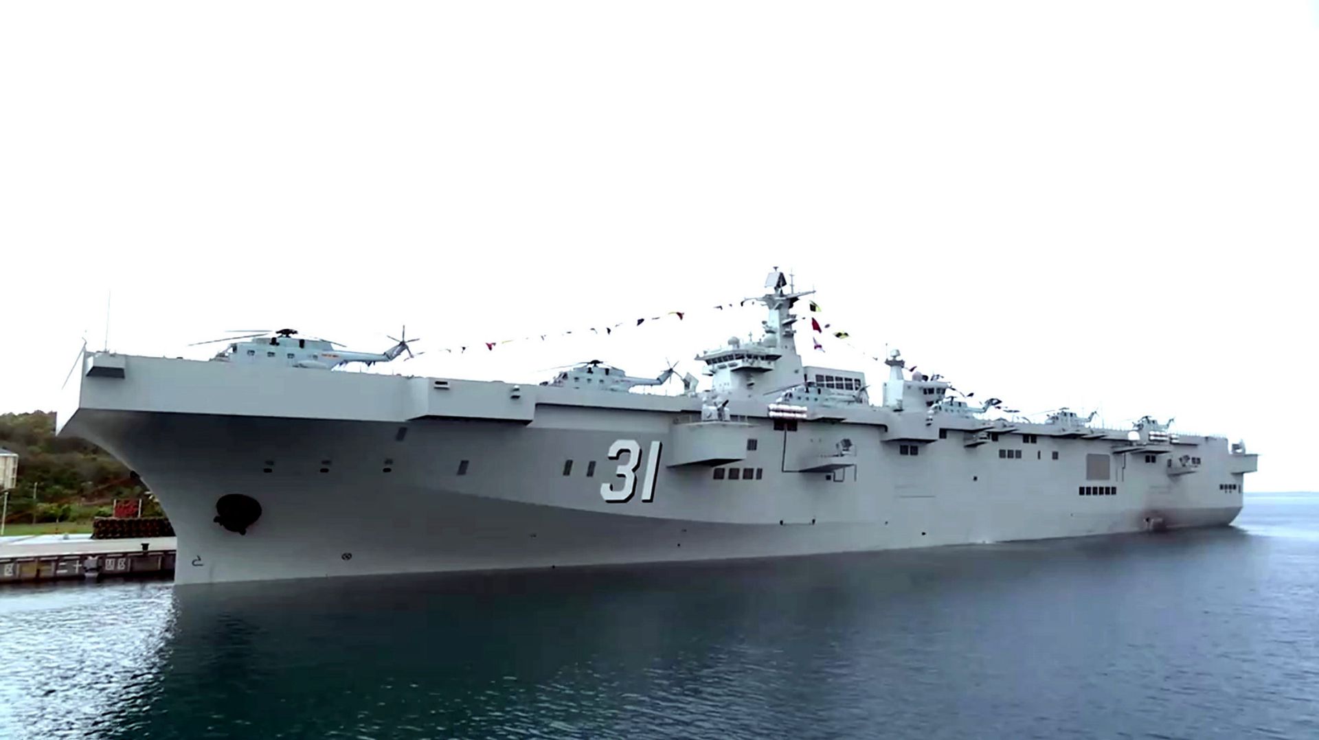 4月23日，中国海军交付三艘巨舰。图为075型两栖攻击舰首舰海南舰，舷号31。（中国央视截图）
