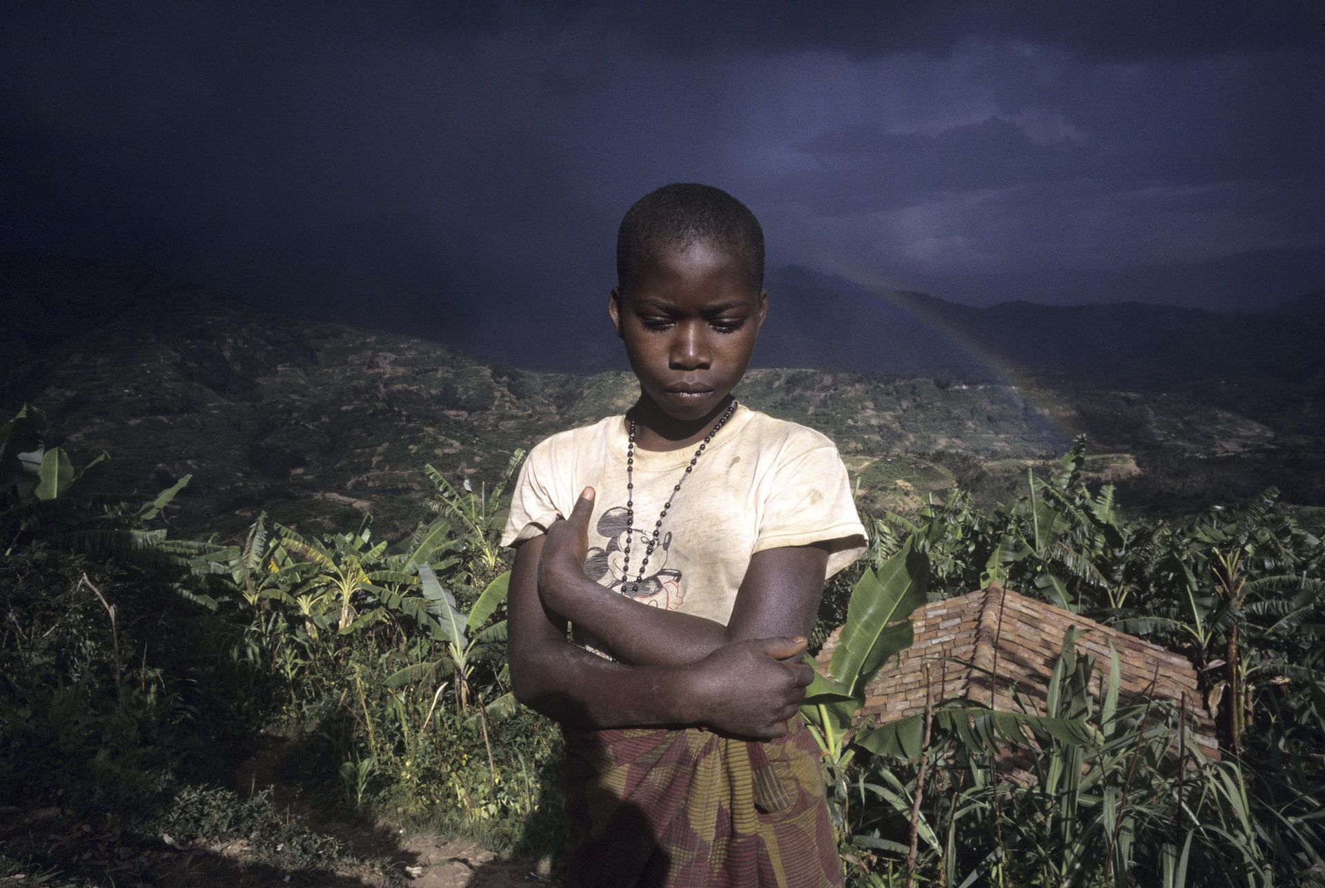 1996年12月：一个孩子在1996年12月在卢旺达的风景前摆姿势。（VCG）