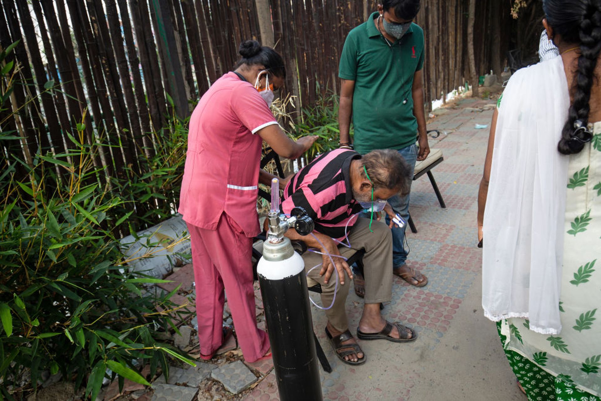 印度新冠肺炎疫情：图为5月8日，班加罗尔（Bengaluru）一名护士正在为呼吸困难的长者扫背。（Getty）
