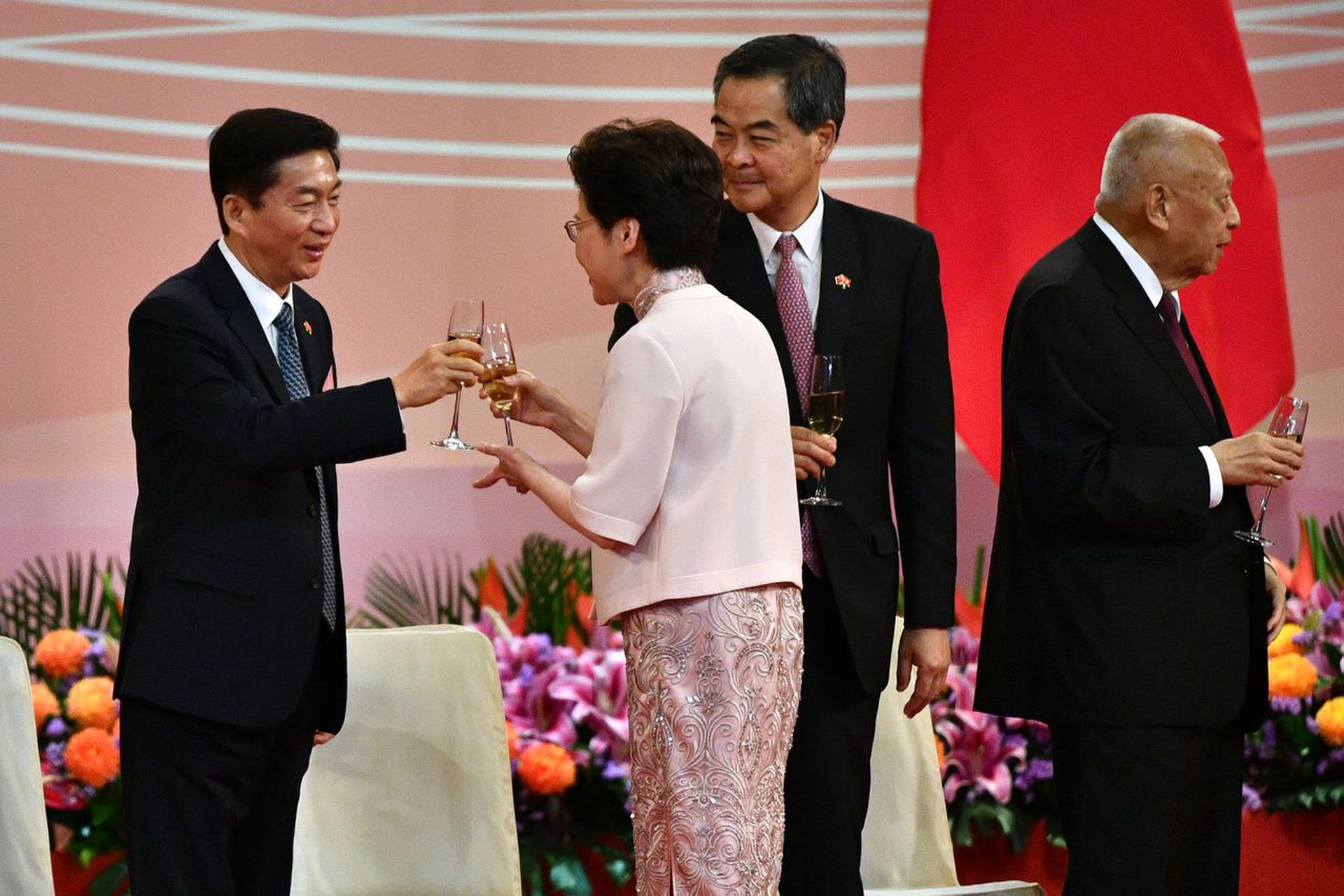 香港政府应与中国中央政府和内地有更多沟通。图为2020年7月1日在香港回归一周年升旗仪式结束后，林郑月娥与骆惠宁（左一）祝酒。（AFP）